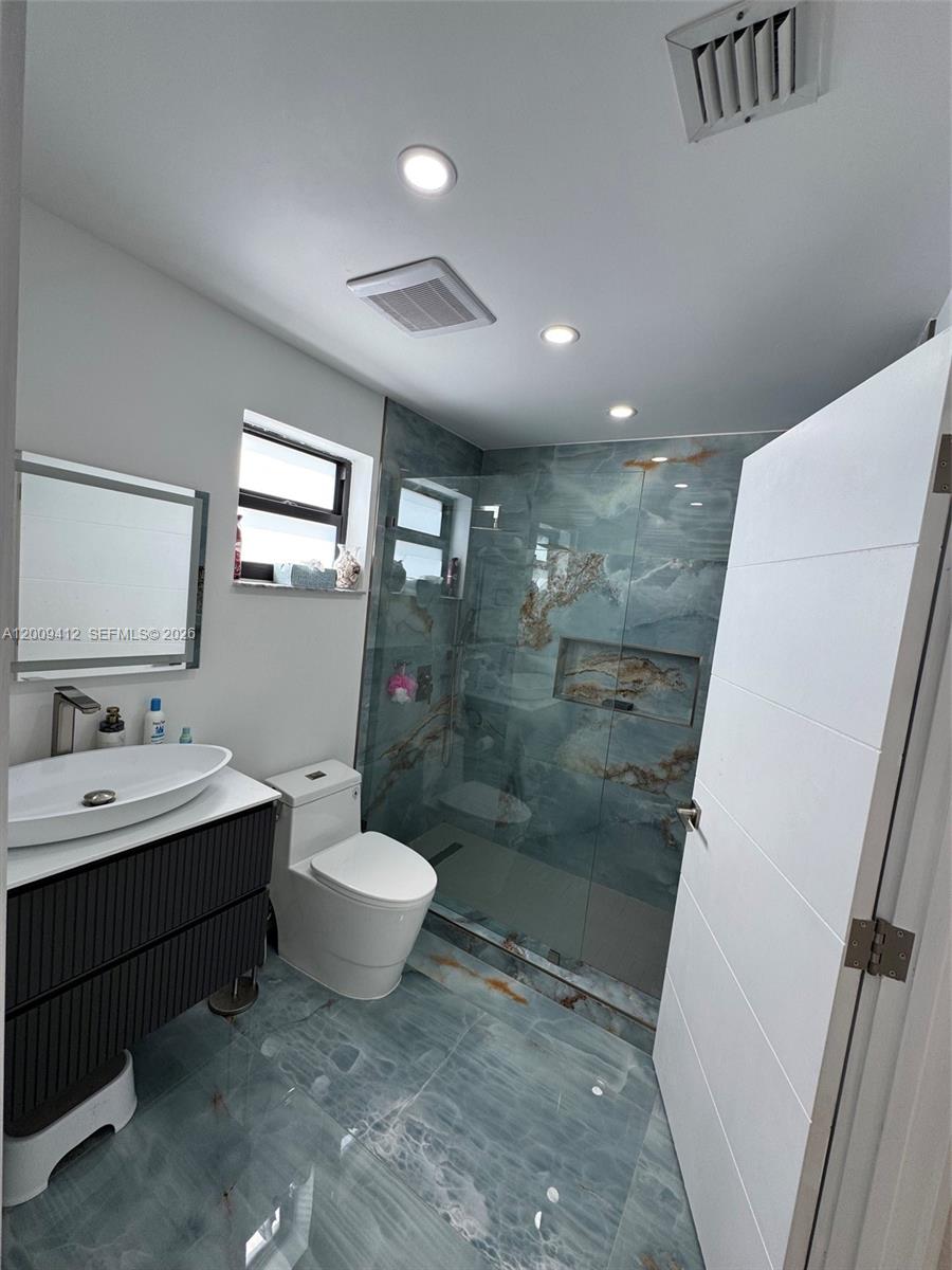 18781 Southwest 294th Terrace Homestead, FL 33030 - Photo 28 of 44 a bathroom with a double vanity sink toilet and shower