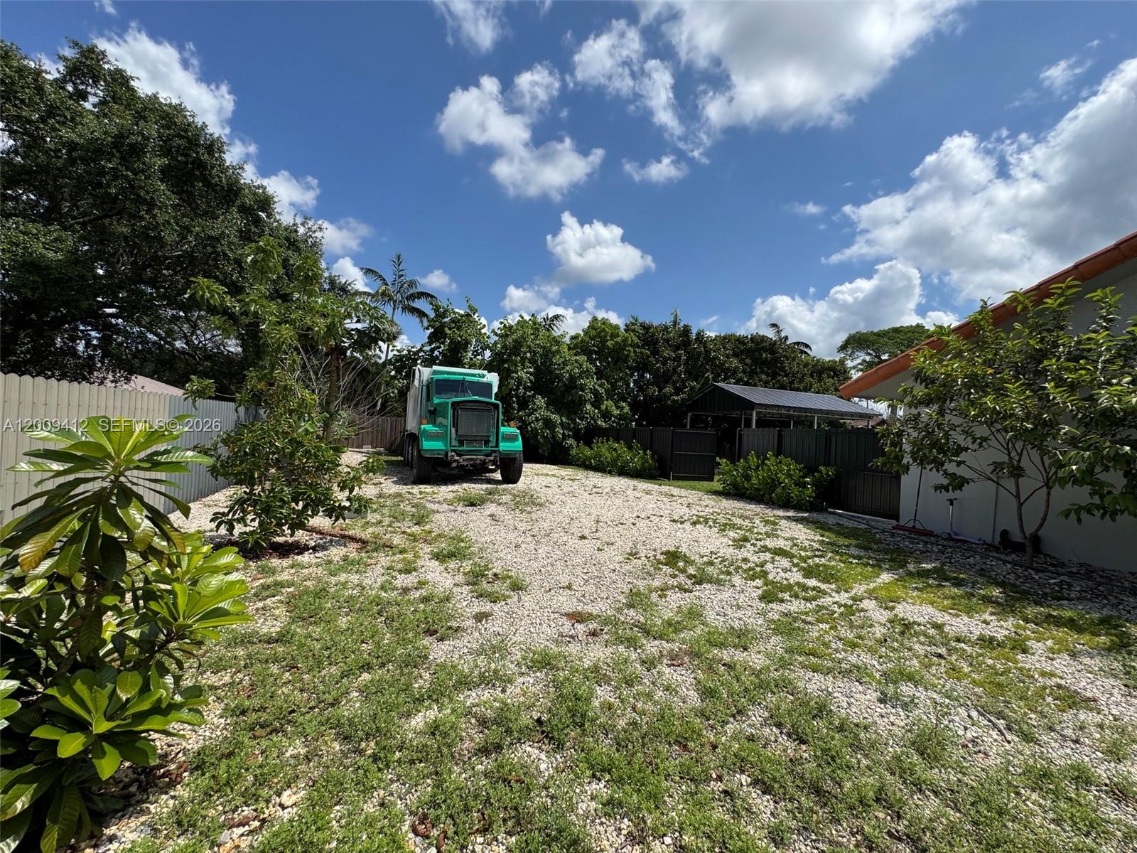 18781 Southwest 294th Terrace Homestead, FL 33030 - Photo 40 of 44 a view of a yard with plants and a large tree
