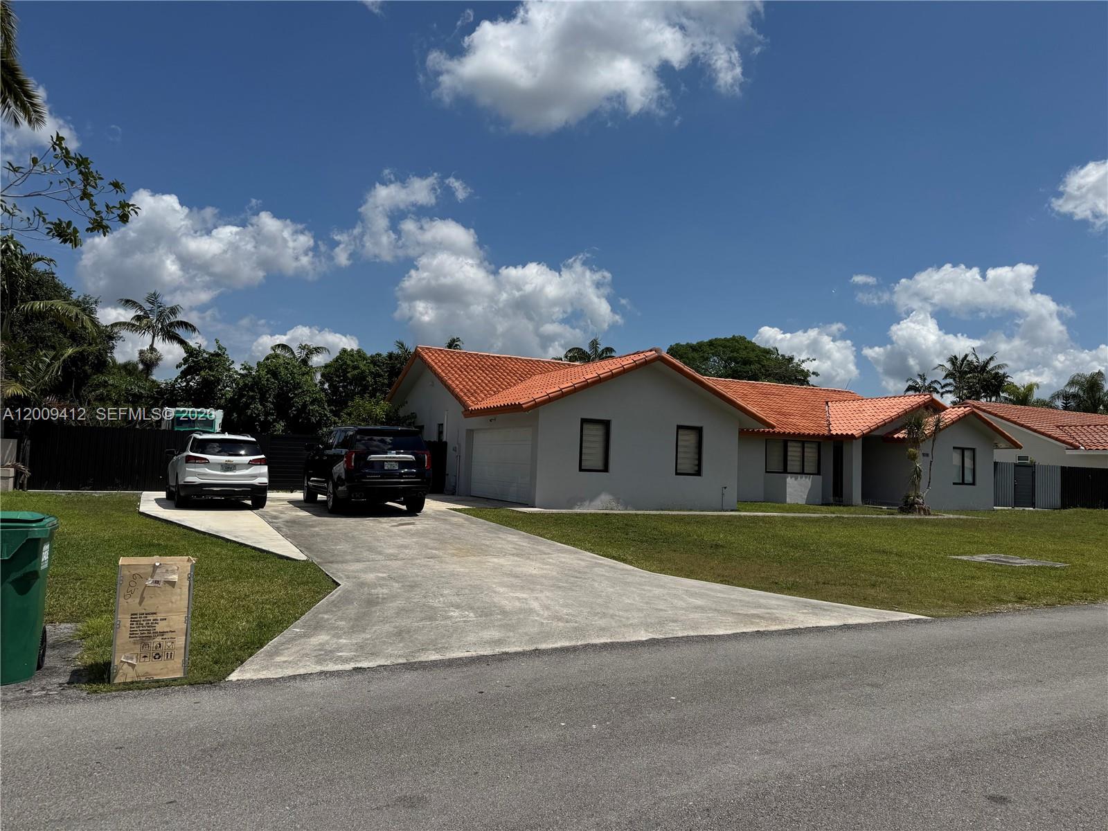 18781 Southwest 294th Terrace Homestead, FL 33030 - Photo 44 of 44 a front view of a house with a yard and garage