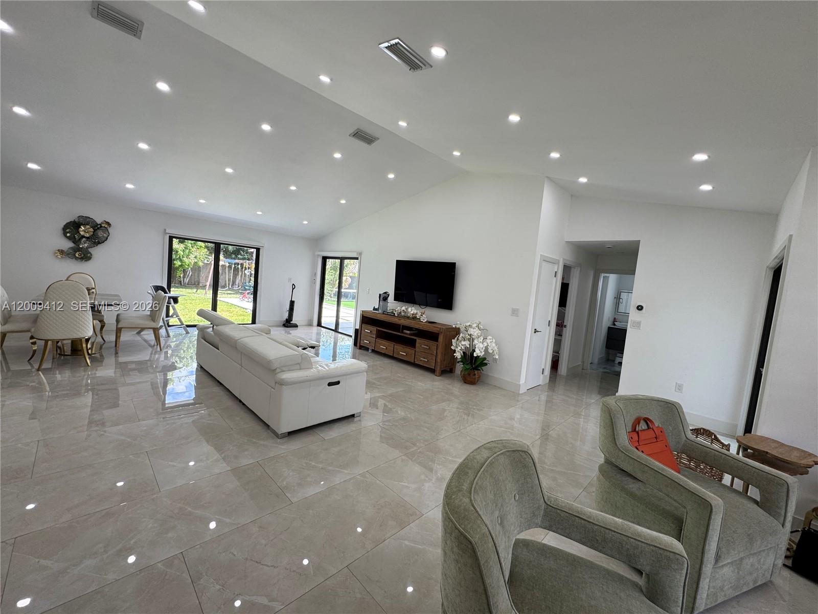 18781 Southwest 294th Terrace Homestead, FL 33030 - Photo 9 of 44 a living room with furniture and a flat screen tv
