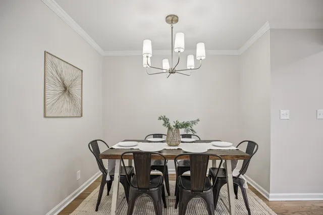 a dining room with furniture and wooden floor