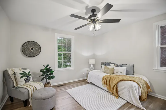 a bedroom with a large bed and a window