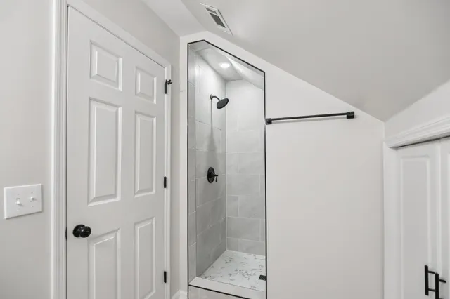 a bathroom with a glass shower door