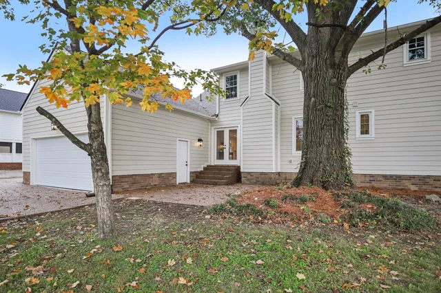 a view of a house with a tree and a yard
