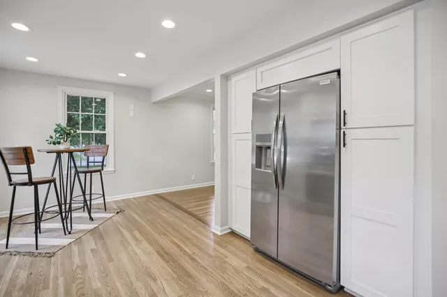 a view of a room with furniture and wooden floor