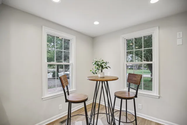 a dining room with furniture and window
