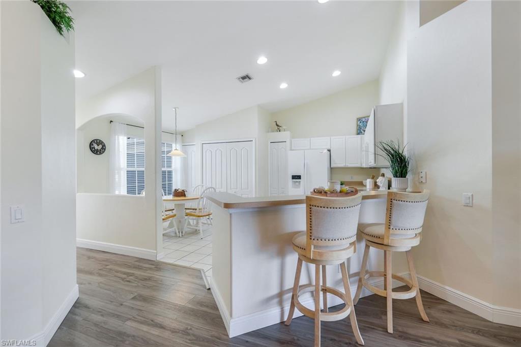 9331 Spring Run Boulevard, Unit 3003 Estero, FL 34135 - Photo 13 of 47 a kitchen with a table and chairs