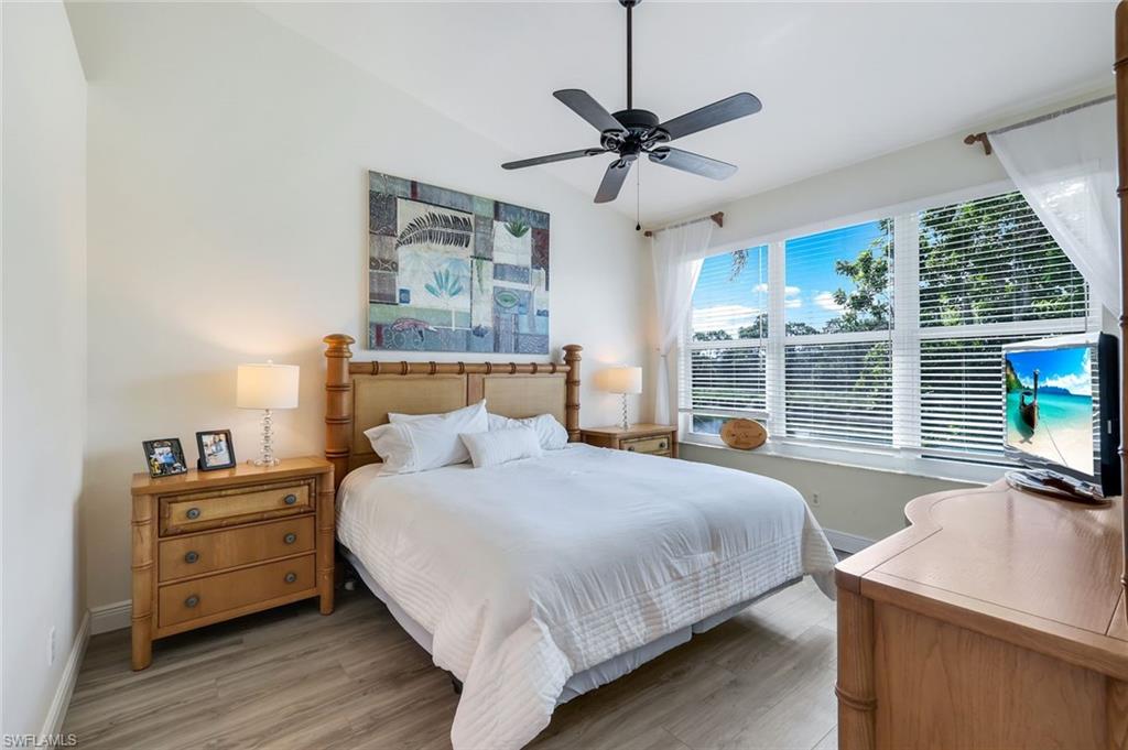 9331 Spring Run Boulevard, Unit 3003 Estero, FL 34135 - Photo 17 of 47 a bedroom with a bed and wooden floor