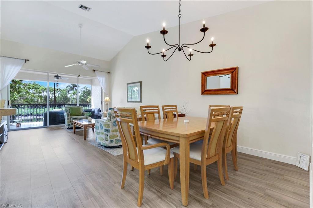 9331 Spring Run Boulevard, Unit 3003 Estero, FL 34135 - Photo 18 of 47 a view of a dining room with furniture window and wooden floor