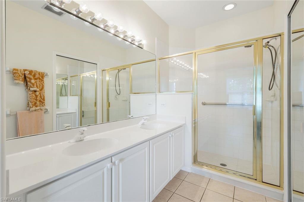9331 Spring Run Boulevard, Unit 3003 Estero, FL 34135 - Photo 19 of 47 a bathroom with a shower sink and mirror