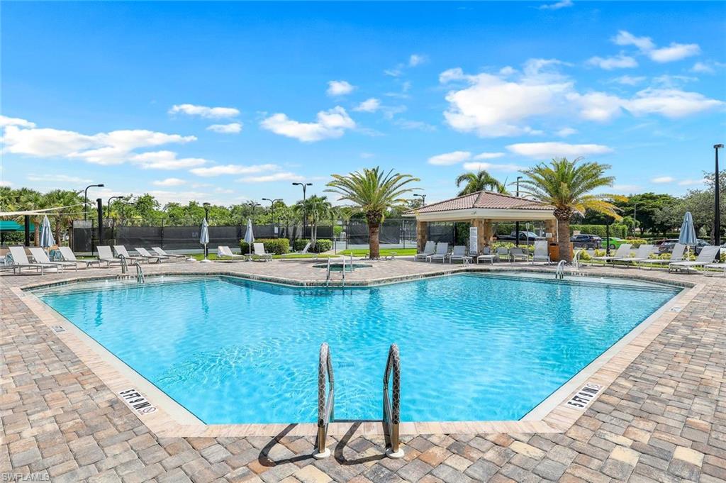 9331 Spring Run Boulevard, Unit 3003 Estero, FL 34135 - Photo 30 of 47 a view of a swimming pool with a lawn chairs