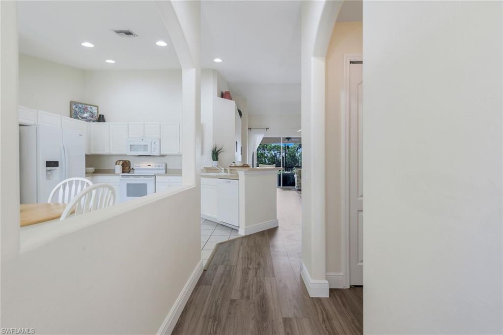 9331 Spring Run Boulevard, Unit 3003 Estero, FL 34135 - Photo 8 of 47 a kitchen with granite countertop a sink and a refrigerator
