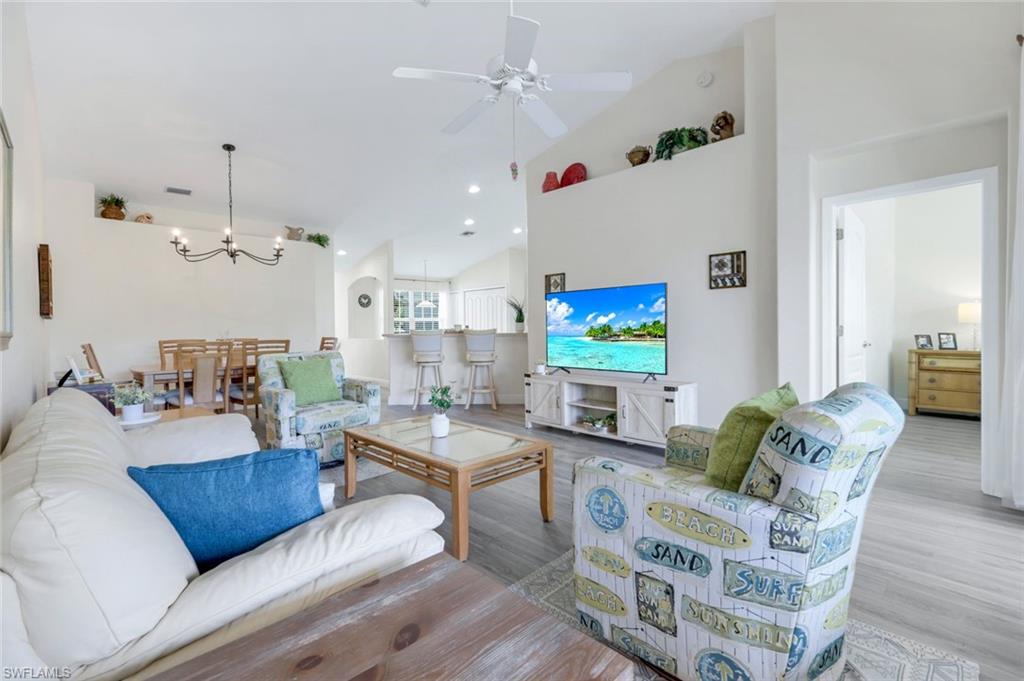 9331 Spring Run Boulevard, Unit 3003 Estero, FL 34135 - Photo 8 of 47 a living room with furniture kitchen view and a chandelier