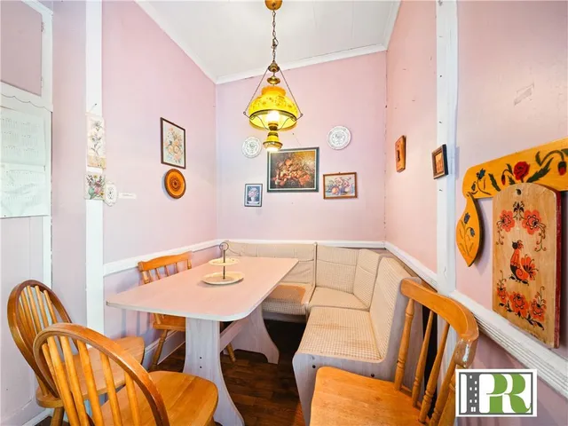 a view of a dining room with a table and chairs