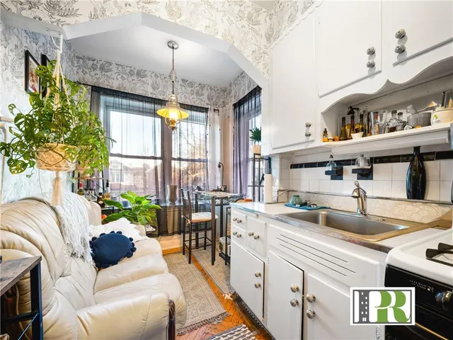 a living room with furniture a fireplace and a chandelier