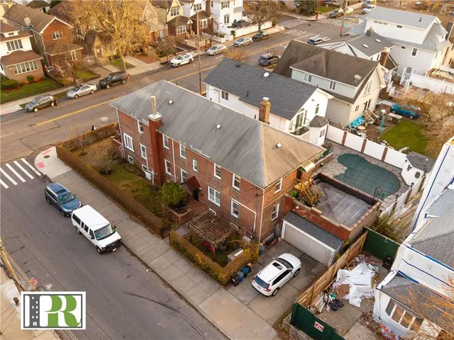 an aerial view of a residential building with parking