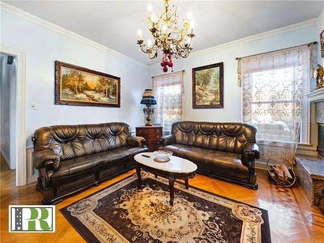 a living room with furniture a rug and a window