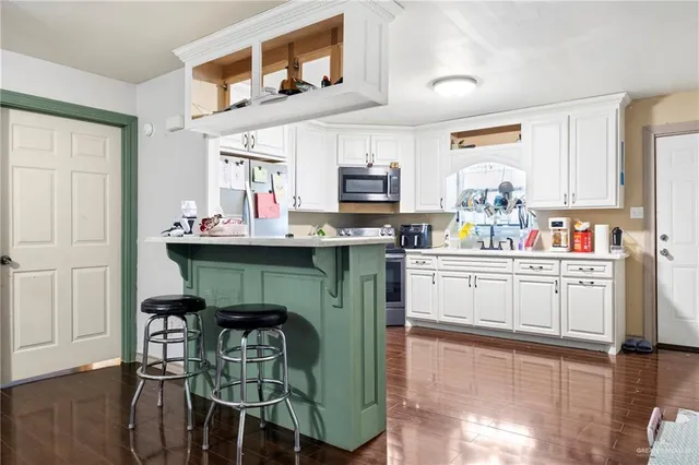 a kitchen with granite countertop a sink cabinets and window