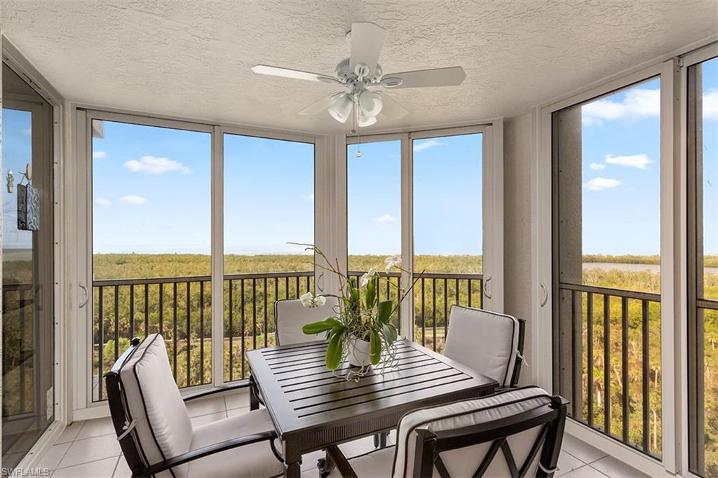 6573 Marissa Loop, Unit 1203 Naples, FL 34108 - Photo 11 of 22 a view of a city from a dining room with furniture window and wooden floor