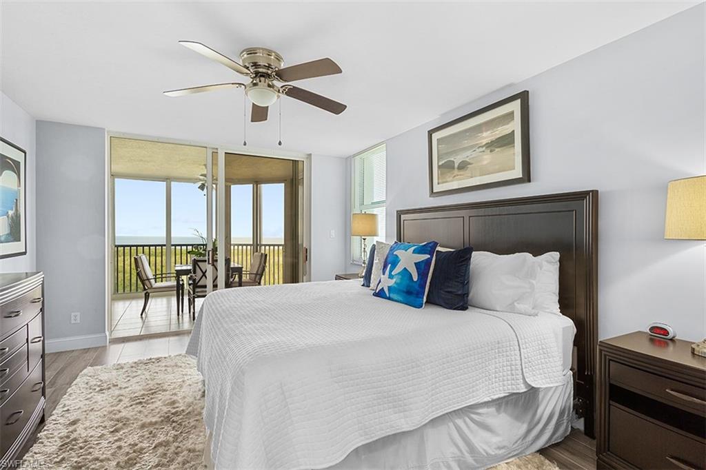6573 Marissa Loop, Unit 1203 Naples, FL 34108 - Photo 7 of 22 a bedroom with a large bed and a large window