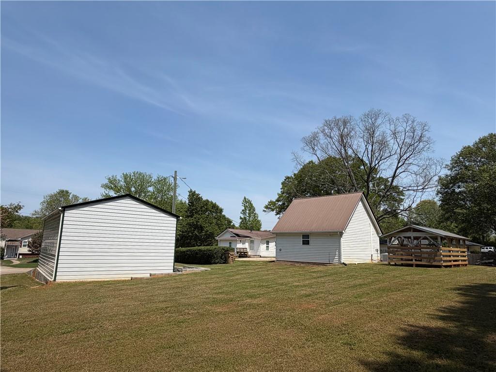 5919 River Road Flowery Branch, GA 30542 - Photo 6 of 18 a view of a house with a backyard