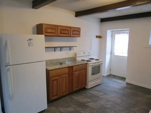 a white refrigerator freezer sitting inside of a kitchen