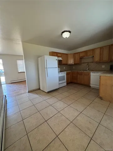 a view of a storage & utility room with two washing machine