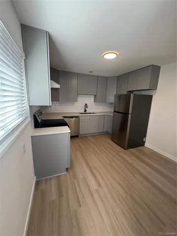 a kitchen with a sink and refrigerator