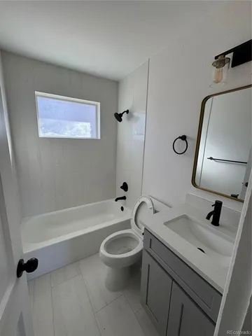 a bathroom with a toilet a sink and bathtub