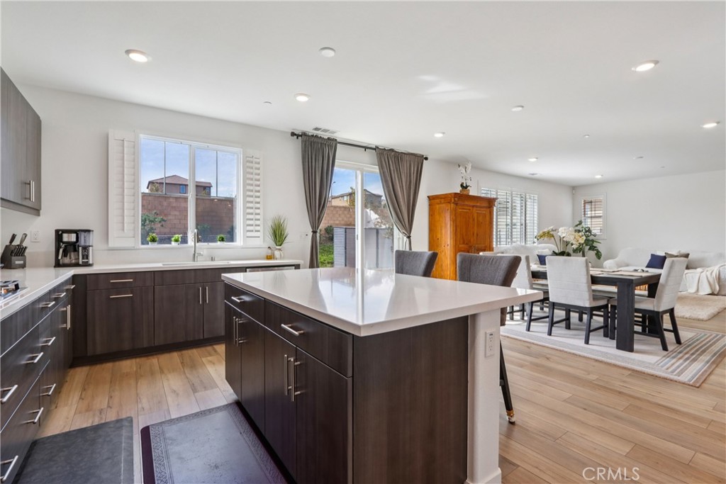 2464 Yellowstone Way Rialto, CA 92377 - Photo 12 of 75 a kitchen with stainless steel appliances granite countertop a table chairs sink and wooden cabinets