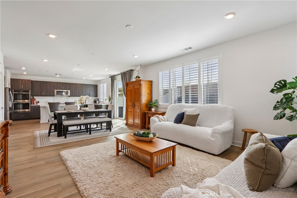 2464 Yellowstone Way Rialto, CA 92377 - Photo 18 of 75 a living room with furniture kitchen view and large windows