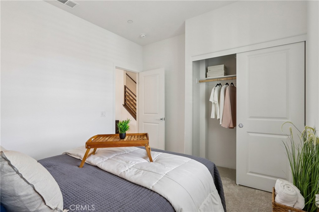 2464 Yellowstone Way Rialto, CA 92377 - Photo 21 of 75 a bedroom with a bed and a potted plant on the dresser