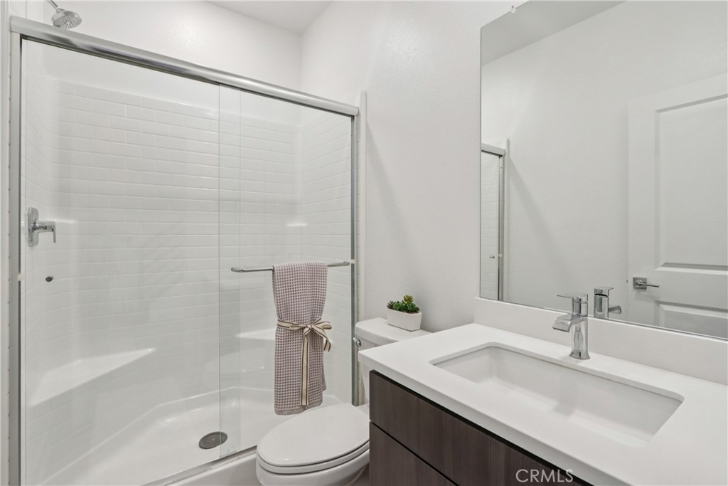 2464 Yellowstone Way Rialto, CA 92377 - Photo 22 of 75 a bathroom with a granite countertop sink toilet and shower