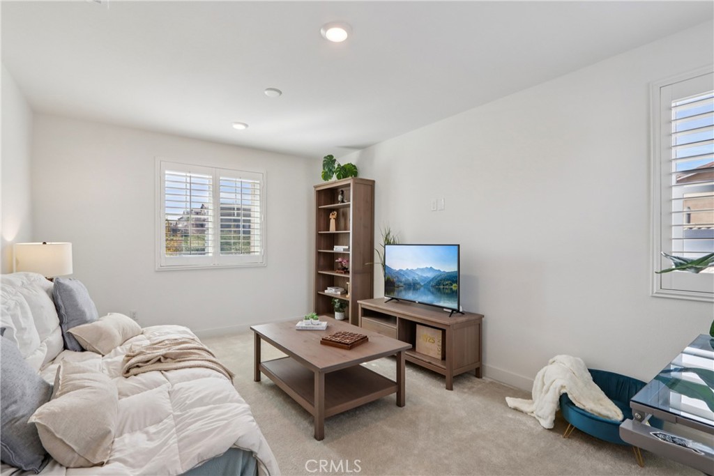 2464 Yellowstone Way Rialto, CA 92377 - Photo 25 of 75 a living room with furniture a window and a flat screen tv