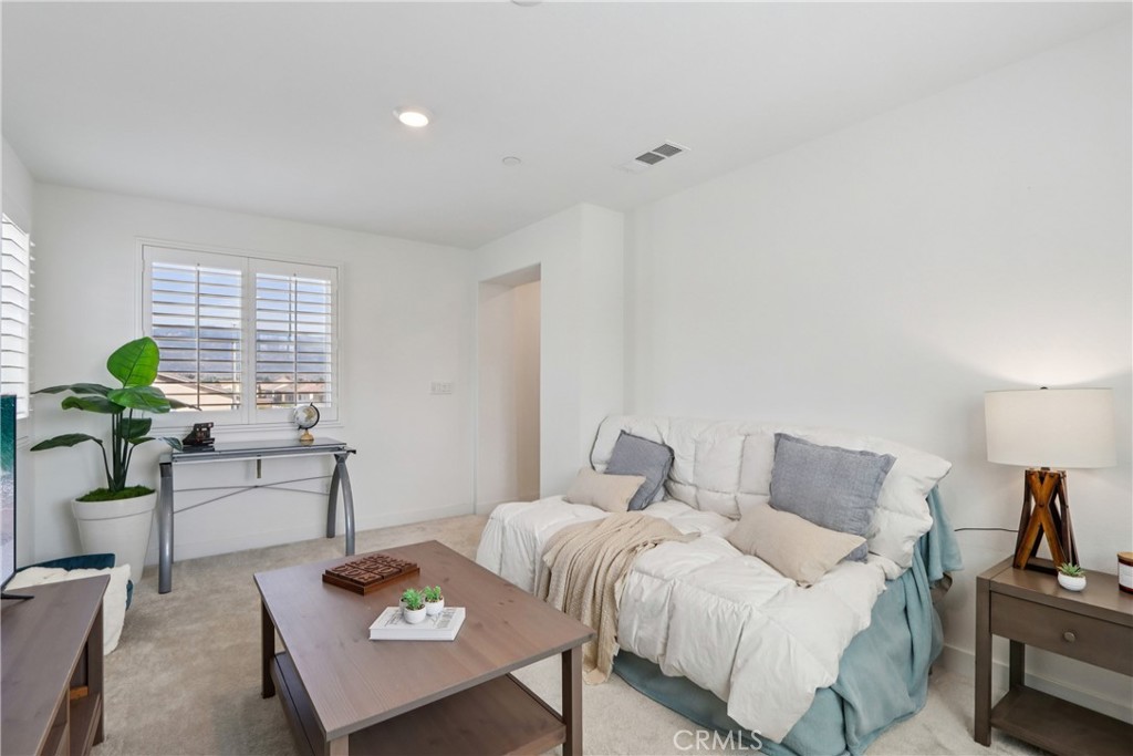 2464 Yellowstone Way Rialto, CA 92377 - Photo 26 of 75 a bedroom with a bed a couch and potted plant on the table