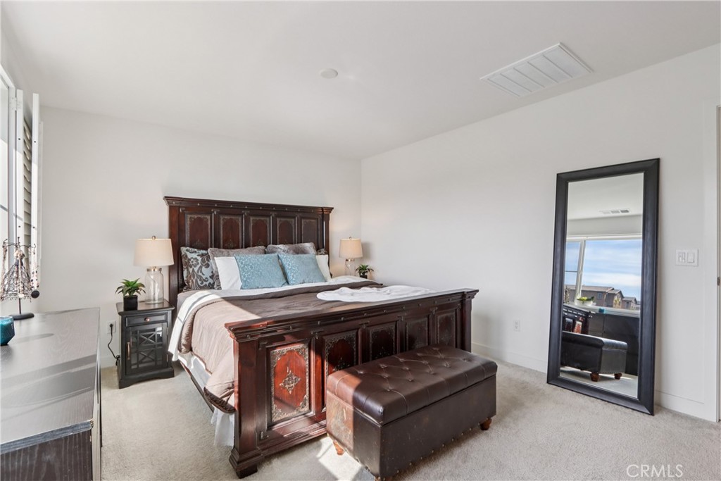 2464 Yellowstone Way Rialto, CA 92377 - Photo 29 of 75 a bed sitting in a bedroom next to a window and a larger closet