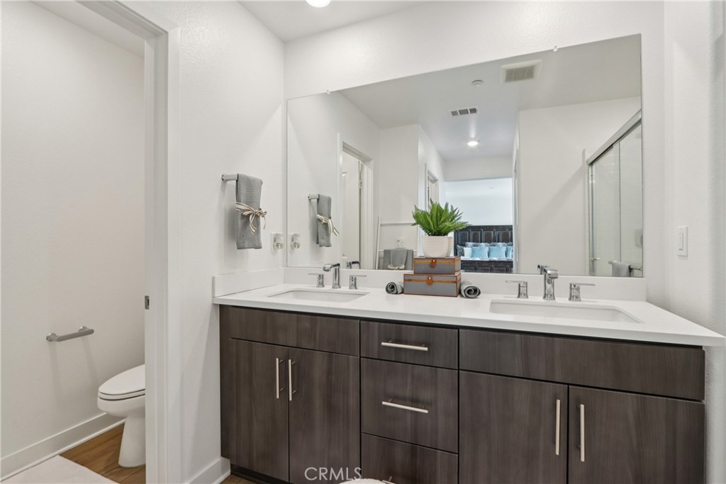 2464 Yellowstone Way Rialto, CA 92377 - Photo 37 of 75 a bathroom with a double vanity sink toilet and mirror