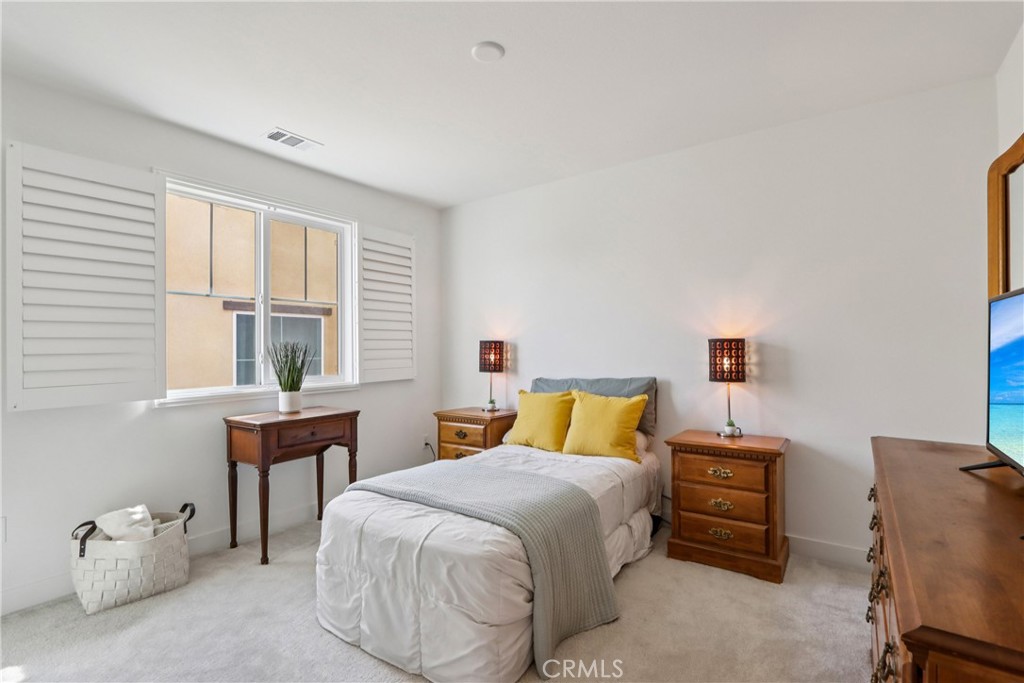 2464 Yellowstone Way Rialto, CA 92377 - Photo 40 of 75 a bedroom with a bed and a window