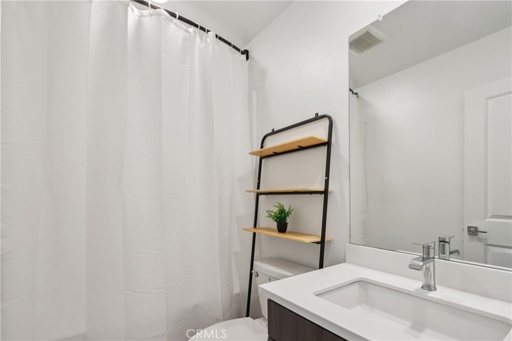 2464 Yellowstone Way Rialto, CA 92377 - Photo 42 of 75 a bathroom with a sink and a mirror