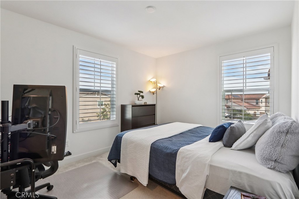 2464 Yellowstone Way Rialto, CA 92377 - Photo 43 of 75 a bedroom with a bed and a flat tv screen on a dresser