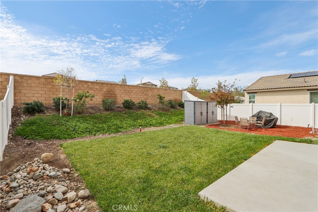 2464 Yellowstone Way Rialto, CA 92377 - Photo 46 of 75 a view of a big house with a big yard and large tree