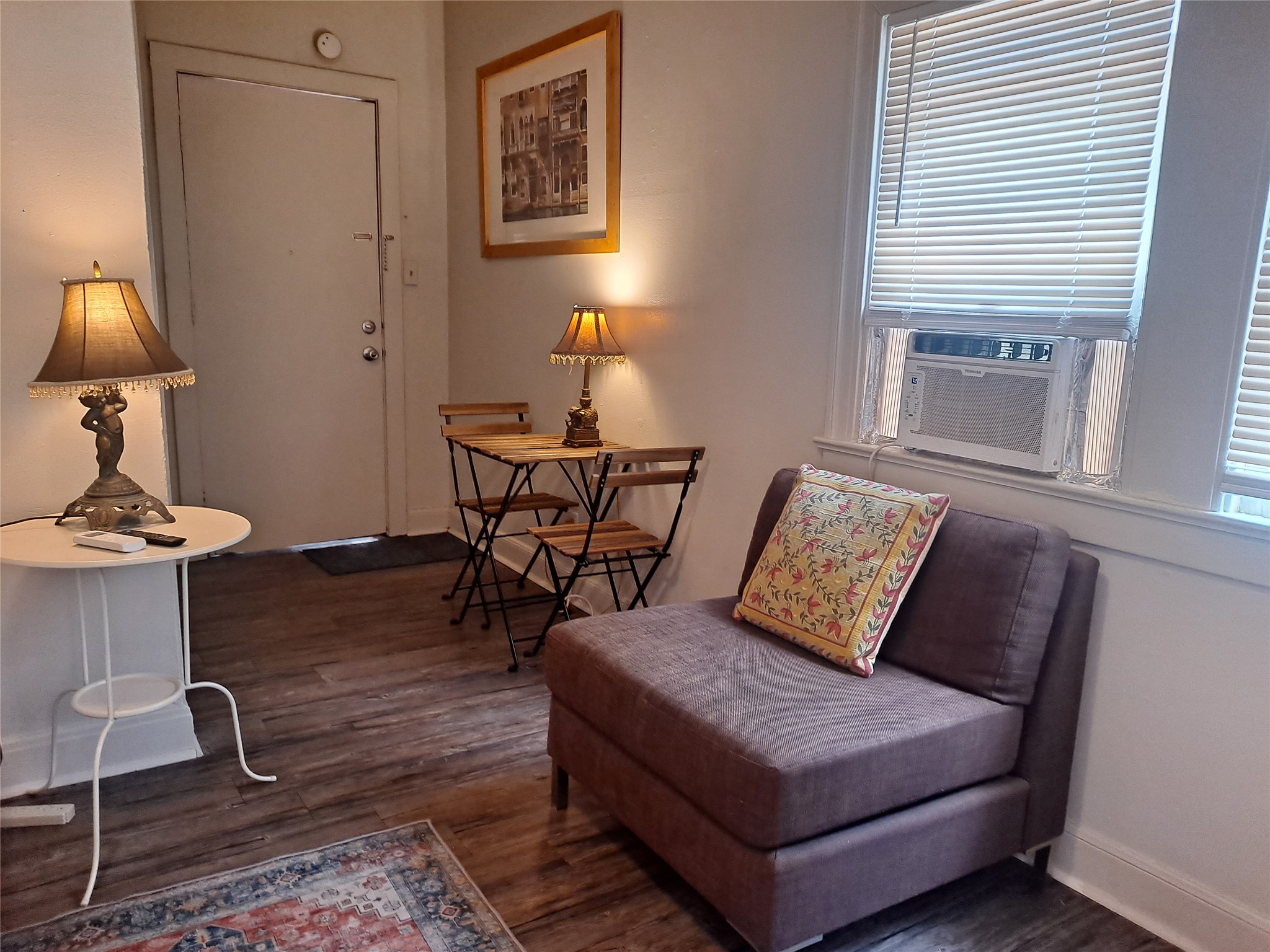 1906 San Gabriel Street, Unit 9 Austin, TX 78705 - Photo 2 of 9 Living area featuring dark wood-style flooring and cooling unit