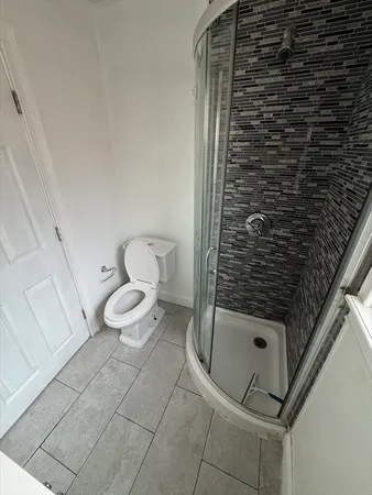 a bathroom with a toilet and a shower
