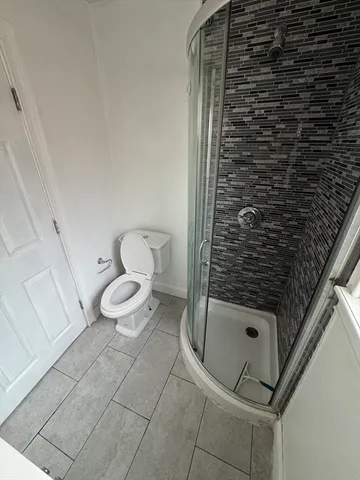 a bathroom with a toilet and a shower