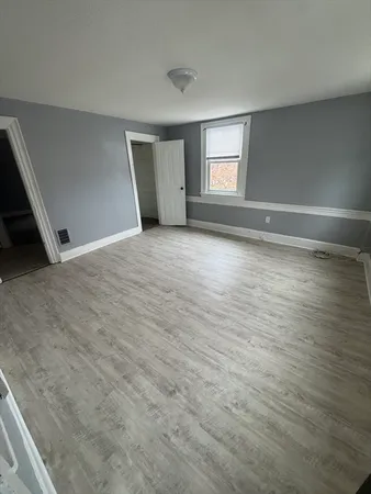 a view of wooden floor and windows in a room