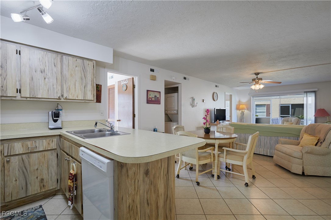 1100 Pondella Road, Unit 801 Cape Coral, FL 33909 - Photo 14 of 24 a kitchen with stainless steel appliances granite countertop a white table and chairs