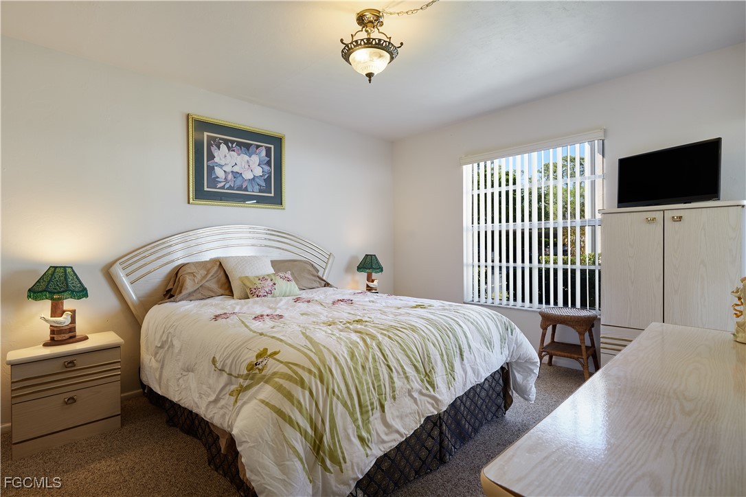 1100 Pondella Road, Unit 801 Cape Coral, FL 33909 - Photo 3 of 24 a spacious bedroom with bed and a window