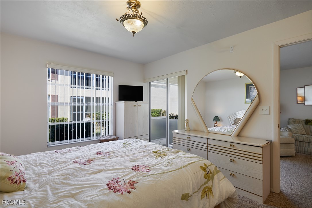 1100 Pondella Road, Unit 801 Cape Coral, FL 33909 - Photo 4 of 24 a bedroom with a bed and a dresser