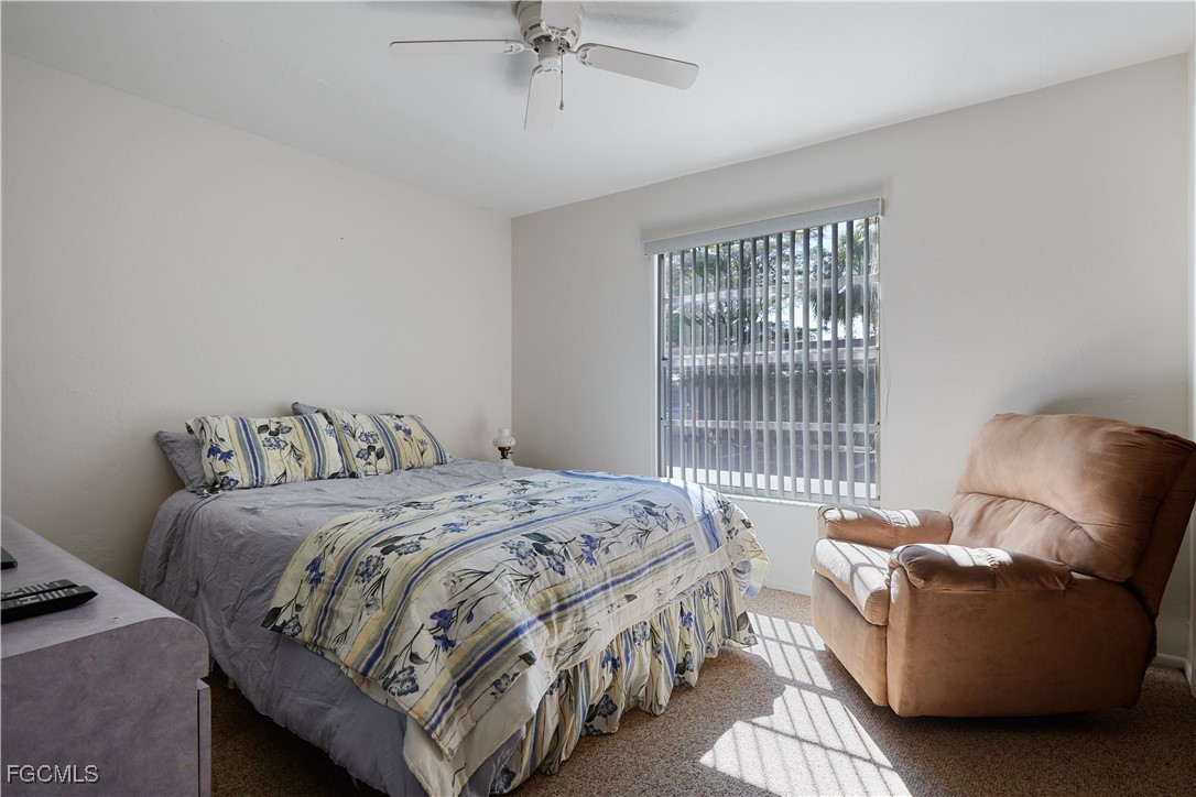 1100 Pondella Road, Unit 801 Cape Coral, FL 33909 - Photo 6 of 24 a bedroom with a bed couch and window