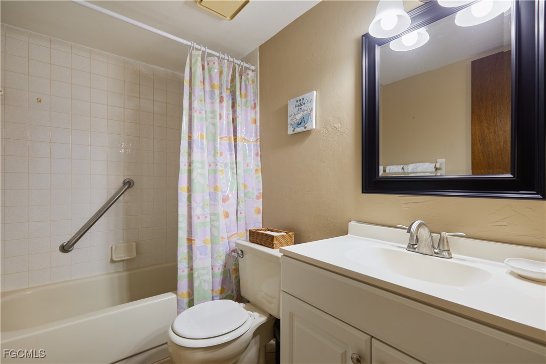 1100 Pondella Road, Unit 801 Cape Coral, FL 33909 - Photo 7 of 24 a bathroom with a sink a toilet and shower
